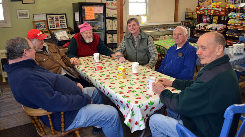 From left: Raymond Joslyn, Walter Shiappini, Larry Wilkes, Dan Joslyn, Merle West, and David Sutter solve the world's problems at The Alna Store on Monday, Feb. 27. Their work will continue under the new ownership, they said. (Abigail Adams photo)