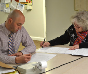 Auditor Fred Brewer and Treasurer Claudia Coffin review town accounts during a meeting of the Edgecomb Board of Selectmen at the town hall Monday, Jan. 30. (Abigail Adams photo)