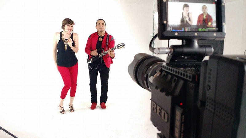 Emily Sabino and her husband, Lenin Sabino, perform during the recent filming of their music video "Con Solo Una Mirada" at a music studio in Lima, Peru. (Photo courtesy Emily Sabino)