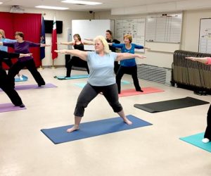 Lincoln County employees strike a warrior pose during a weekly yoga class Tuesday, Jan. 31. The class is one of several new programs established by the county's wellness committee. (Photo courtesy Carrie Kipfer)