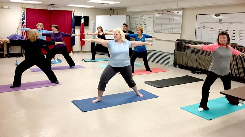 Lincoln County employees strike a warrior pose during a weekly yoga class Tuesday, Jan. 31. The class is one of several new programs established by the county's wellness committee. (Photo courtesy Carrie Kipfer)