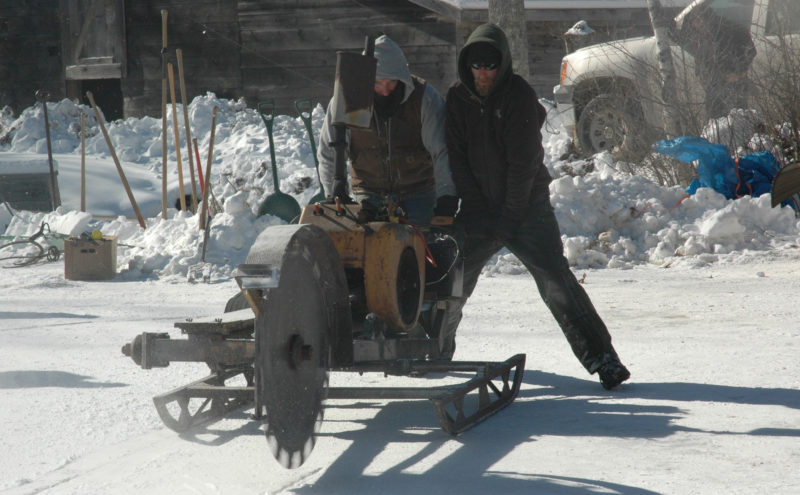 Thompson Ice House Preservation Corp. President Ken Lincoln and his son, Kyle Lincoln, operate an ice saw during the annual ice harvest Feb. 14, 2016. (Maia Zewert photo, LCN file)