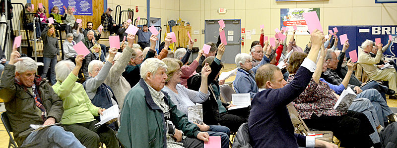 Bristol residents vote on the education budget during the annual town meeting at Bristol Consolidated School on Tuesday, March 21. (Maia Zewert photo)