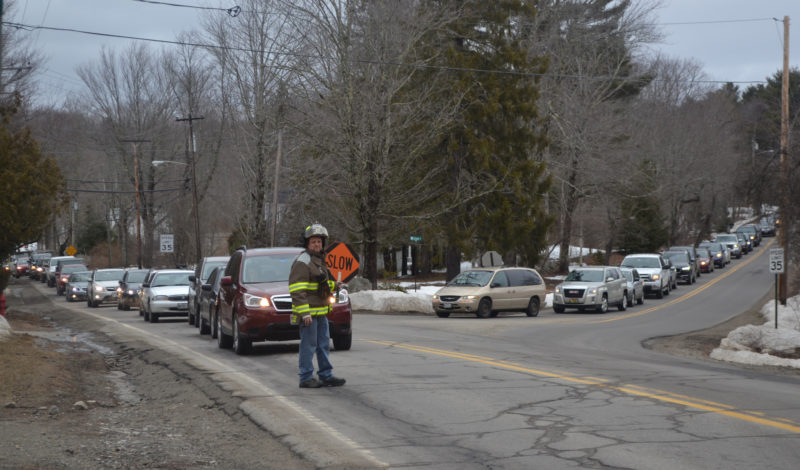 A Damariscotta firefighter directs traffic at the intersection of Bristol Road and School Street after a single-vehicle accident the afternoon of Tuesday, March 28. (Maia Zewert photo)