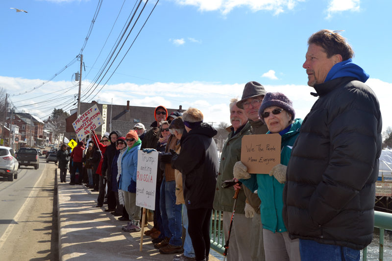 People stand on the Damariscotta-Newcastle bridge during a rally in support of constitutional rights Sunday, March 19. (Maia Zewert photo)