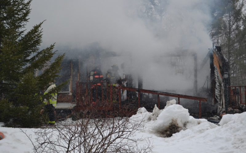 Area firefighters extinguish hot spots at 606 Middle Road in Dresden after fire gutted the building the morning of Friday, March 24. (Abigail Adams photo)
