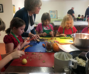 Students receive instruction from Jean Kerrigan, the general manager of Damariscotta River Grill.