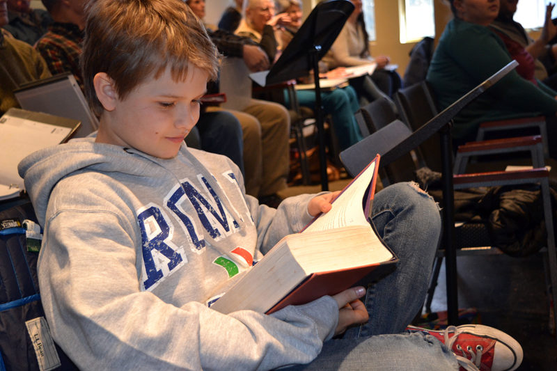 Andrew Lyndaker, who plays Michael Banks in Lincoln County Community Theater's upcoming production of "Mary Poppins," buries himself in a book while awaiting his turn to sing. (Christine LaPado-Breglia photo)