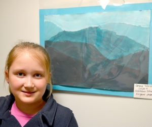 Nobleboro Central School fourth-grader Grace Ward poses with her painted "kirigami" piece on Wednesday, March 8 at The Lincoln Home in Newcastle. (Christine LaPado-Breglia photo)