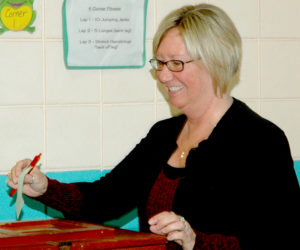 Nobleboro Town Clerk Susan Pinnetti-Isabel casts her ballot on the education budget during the annual town meeting at Nobleboro Central School on Saturday, March 18. (Alexander Violo photo)