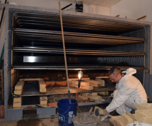 Norbert Creutzer works on the masonry for the new oven at Borealis Breads in Waldoboro on Friday, March 3. Creutzer works for the French manufacturer and traveled to Waldoboro to assemble the oven, a job that includes electrical work, masonry, and welding. (J.W. Oliver photo)
