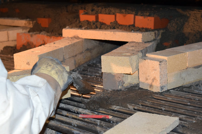 Norbert Creutzer works on the masonry in the new oven at Borealis Breads in Waldoboro. (J.W. Oliver photo)