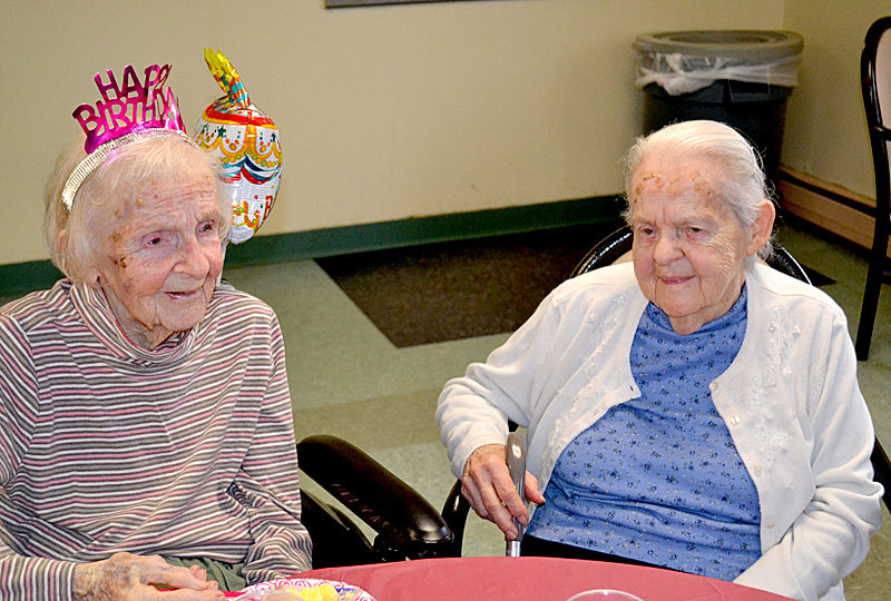 Lillie Weissenberger (left) celebrates her 100th birthday Monday, March 27 at the Country Manor Nursing Home in Whitefield with her sister, Beverly Travers, by her side. (Abigail Adams photo)