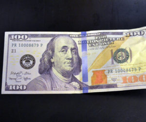 The Damariscotta Police Department is warning area businesses and residents to be on the lookout for fake $100 bills like this movie prop, recently passed at a local business. (Maia Zewert photo)
