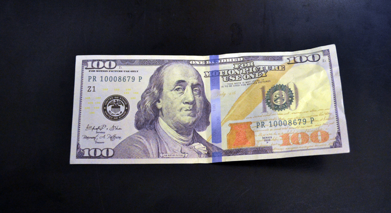 The Damariscotta Police Department is warning area businesses and residents to be on the lookout for fake $100 bills like this movie prop, recently passed at a local business. (Maia Zewert photo)