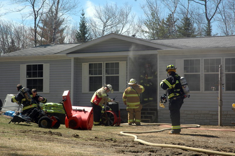Firefighters set up a fan to clear the home of smoke after a fire on South Clary Road in Jefferson. (Alexander Violo photo)