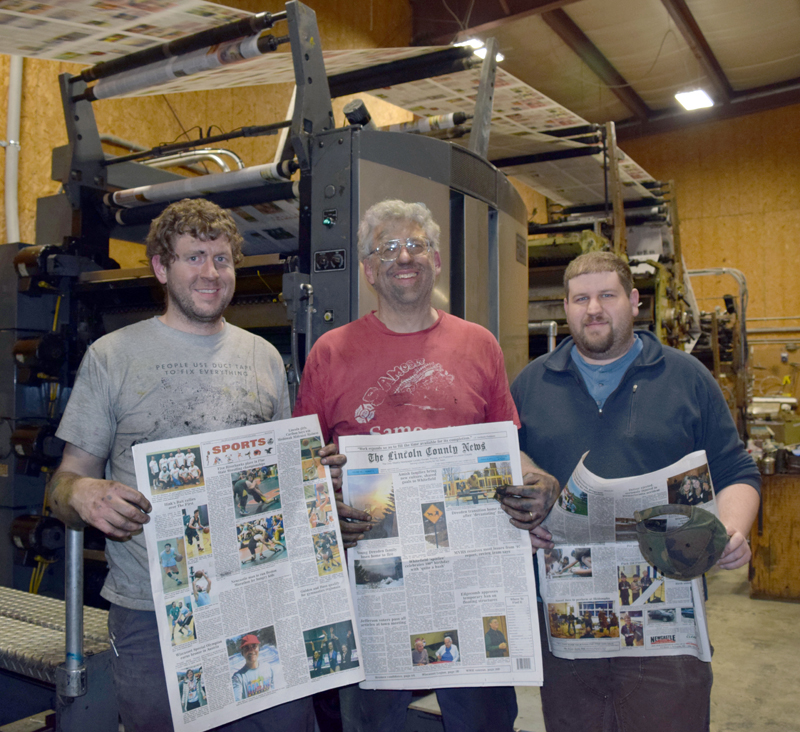 After working all night to complete the installation of two new color units, The Lincoln County News Publisher Chris Roberts (center) and Associate Publishers John Roberts (left) and Allan Roberts hold copies of the March 30 edition. (J.W. Oliver photo)