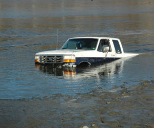 A truck went into the water, attempting to pick up a boat, at Pine Street Landing in Waldoboro on the afternoon of Sunday, April 9. (Alexander Violo photo)