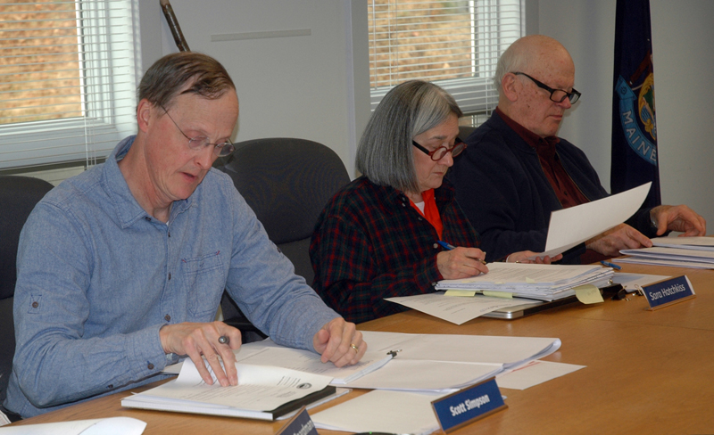 From left: Waldoboro Planning Board members Scott Simpson, Sara Hotchkiss, and Ted Wooster review documents for the First Baptist Church of Waldoboro's sanctuary project. (Alexander Violo photo)