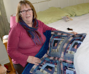 Robin Chase holds a quilt members of the Amish community made from her late son's shirts. (Abigail Adams photo)