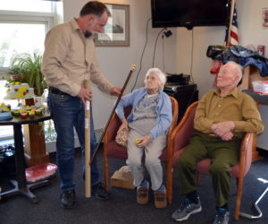 Wiscasset Selectman Benjamin Rines, Jr. (standing), presents the Boston Post Cane to Ruth Applin, who celebrated her 100th birthday Easter Sunday, during an open house at the Wiscasset Community Center. Seated next to Ruth is her 99 year old brother Arthur Jones, who is also the recipient of the Boston Post Cane in the town of Nobleboro. (Charlotte Boynton photo)