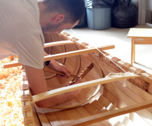 Intern Tobias Francis installs a rib on the Wabanaki birch-bark canoe to be launched at the Damariscotta town landing on Thursday, April 27.