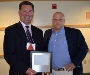 Hall Funeral Home President Mike Hall was presented the Damariscotta Region Chamber of Commerce's Business Person of the Year Award by outgoing board member John Bottero during the chamber's annual meeting Thursday, May 18. (Maia Zewert photo)