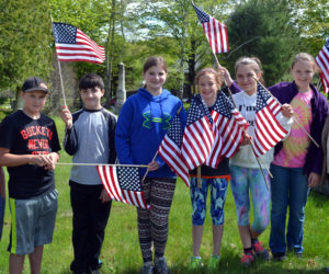 From left: Edgecomb Eddy School sixth-graders Jack Castonia, Connor Wenners, Anthony Gelormine, Carolyn Potter, Brynna Nelson, Nathalie Paulino, Kathryn Hibbrard, and teacher Terry Mulligan at the North Edgecomb Cemetery on Tuesday, May 23. (Abigail Adams photo)