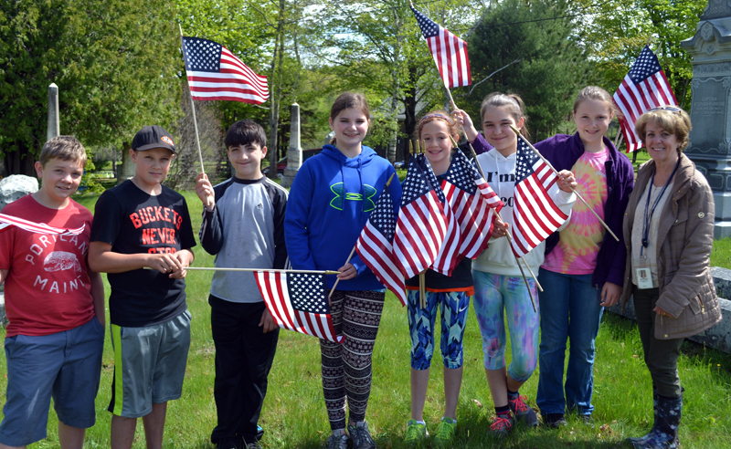 From left: Edgecomb Eddy School sixth-graders Jack Castonia, Connor Wenners, Anthony Gelormine, Carolyn Potter, Brynna Nelson, Nathalie Paulino, Kathryn Hibbrard, and teacher Terry Mulligan at the North Edgecomb Cemetery on Tuesday, May 23. (Abigail Adams photo)