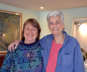 Damariscotta artist Marnie Sinclair (left) and her friend Deb Poor are all smiles in the dining-room-turned-art gallery on the first floor of Poor's River Road home. (Christine LaPado-Breglia photo)