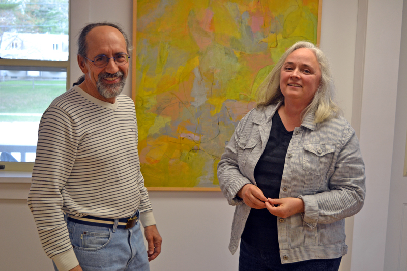 Alice de Mauriac stands before one of her paintings with her husband, Julio Sanchez-Banos, in the main gallery of River Arts. (Christine LaPado-Breglia photo)