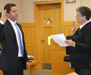 Sagadahoc County Clerk of Courts Anita Alexander administers the oath of office to District Attorney Jonathan Liberman at West Bath District Court on Friday, May 19. (Abigail Adams photo)