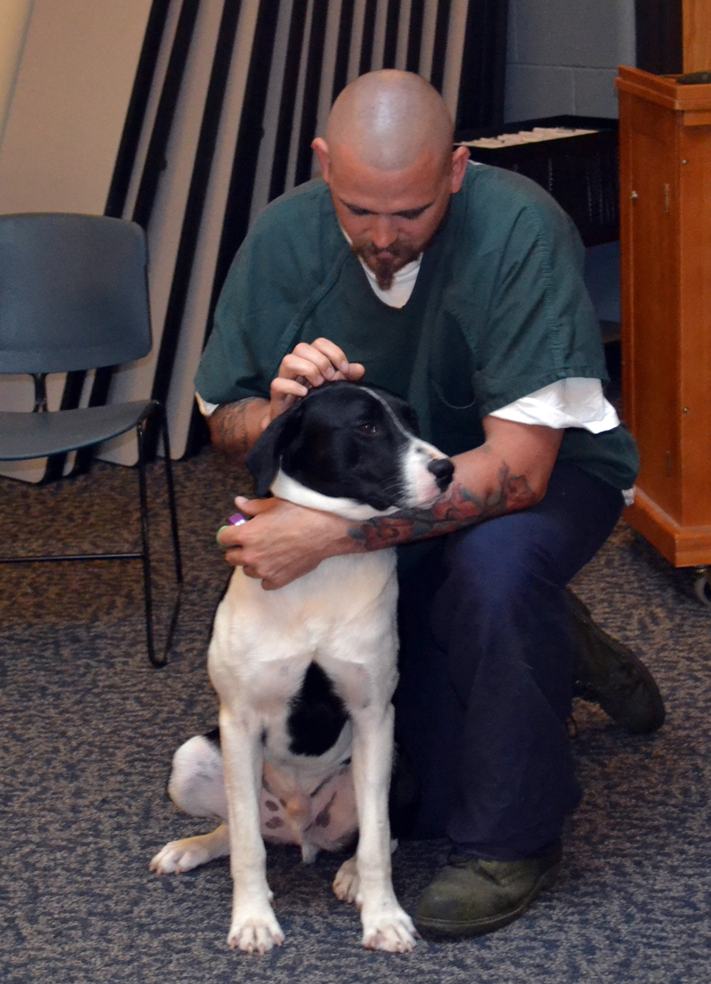 Two Bridges Regional Jail inmate Dustin Campbell says goodbye to Jake, who graduated from the jail's new Beyond the Bars dog obedience training program Tuesday, May 23. (Abigail Adams photo)