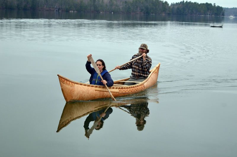 Sarah Gladu and Steve Cayard return to shore on the maiden voyage of the traditional Wabanaki canoe built by Cayard and others in Lincoln Academy's Cable-Burns Applied Technology and Engineering Center. (Christine LaPado-Breglia photo)