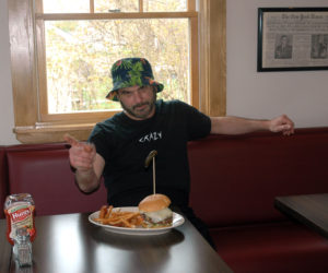 Mario Panagos with one of his burger creations at the Burger Bar in Waldoboro. (Alexander Violo photo)