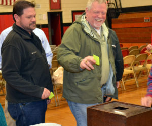 Wiscasset School Committee Chair Michael Dunn (left) and committee member Glen Craig vote by secret ballot on the Wiscasset School Department budget at the annual budget meeting Monday, May 15. (Abigail Adams photo)