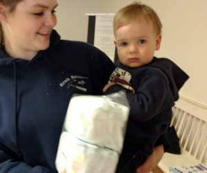 Volunteers Emily and Raylan Krah help distribute diaper packets at the Ecumenical Food Pantry in Newcastle. (Photo courtesy Sue Rockwood)