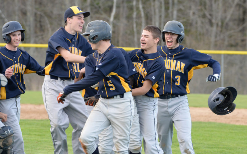 Medomak Valley's baseball team celebrate their 10 inning 5-4 win over Lincoln Academy on May 9 in Waldoboro.  (Paula Roberts photo)