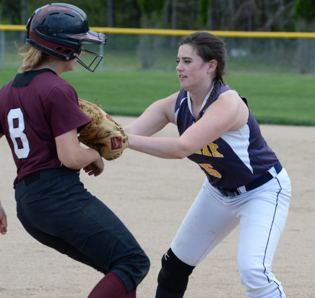 Medomak first baseman Lydia Simmons fi elded a ground ball and tags out Savannah McTogue. (Paula Roberts photo)