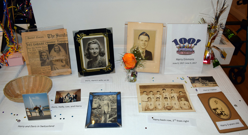 A table at Harry Emmons' 100th birthday party includes photos from his life, as well as his engagement and wedding announcements. (J.W. Oliver photo)