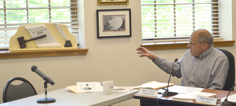 Damariscotta Town Manager Matt Lutkus points out a recently restored 1959 wood carving by the late Damariscotta artist Maurice "Jake" Day during a Damariscotta Board of Selectmen meeting Wednesday, June 7. (Maia Zewert photo)