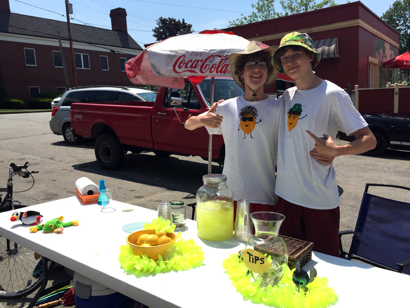 Friends and business partners Dylan Squiers (left) and Dawson French at their lemonade stand, Sugar Daddy's Lemonade, in Damariscotta on Monday, June 12. French designed and made their shirts. (Maia Zewert photo)