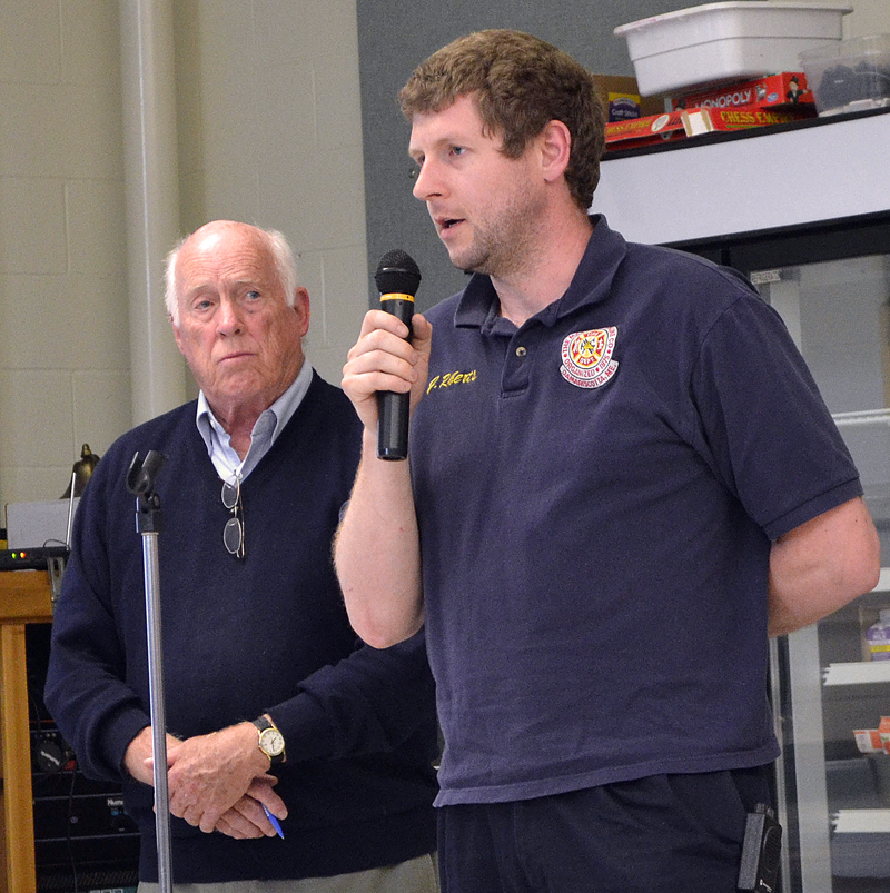 Moderator Don Means (left) looks on as Damariscotta Fire Chief John Roberts talks about the department's fundraising efforts during annual town meeting Wednesday, June 14. (Maia Zewert photo)