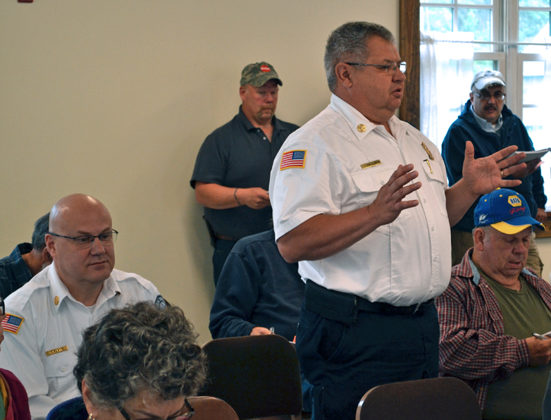 Gardiner Fire and Rescue Chief Al Nelson speaks at Dresden's annual town meeting Saturday, June 17, as Wiscasset Ambulance Service Director Toby Martin (left) looks on. (Abigail Adams photo)