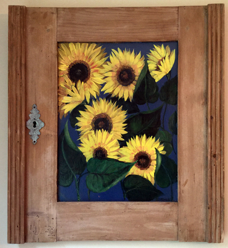 This painting of sunflowers on a salvaged cupboard door by Florida artist Diane Tonelli is one of many paintings to be on display at the upcoming "Art in Bloom" show at the St. Andrew's Episcopal Church Parish House in Newcastle. (Photo courtesy Ruth Piper)