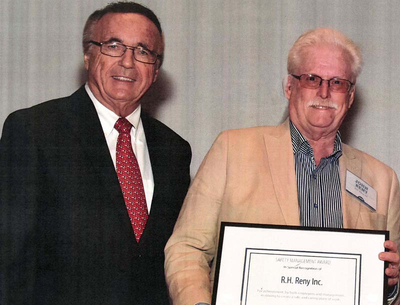 R.H. Reny Inc. President John Reny (right) receives an award for outstanding safety performance during the Maine EmployersÂ’ Mutual Insurance Co.Â’s annual meeting of policyholders in early June.