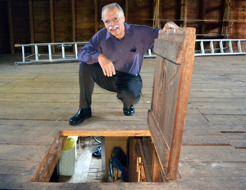 The Rev. Stan LeQuire holds a trap door open in the hay loft of The First Baptist Church of Nobleboro's barn Wednesday, June 7. (J.W. Oliver photo)