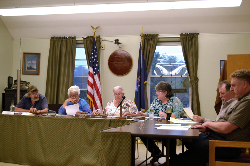 The Wiscasset Board of Selectmen votes to place the harbor master and shellfish warden under the authority of the police department Tuesday, June 27. From left: Selectmen Robert Blagden, Katharine Martin-Savage, and Judy Colby; Town Manager Marian Anderson; and Selectmen Benjamin Rines Jr. and Jefferson Slack. (Charlotte Boynton photo)