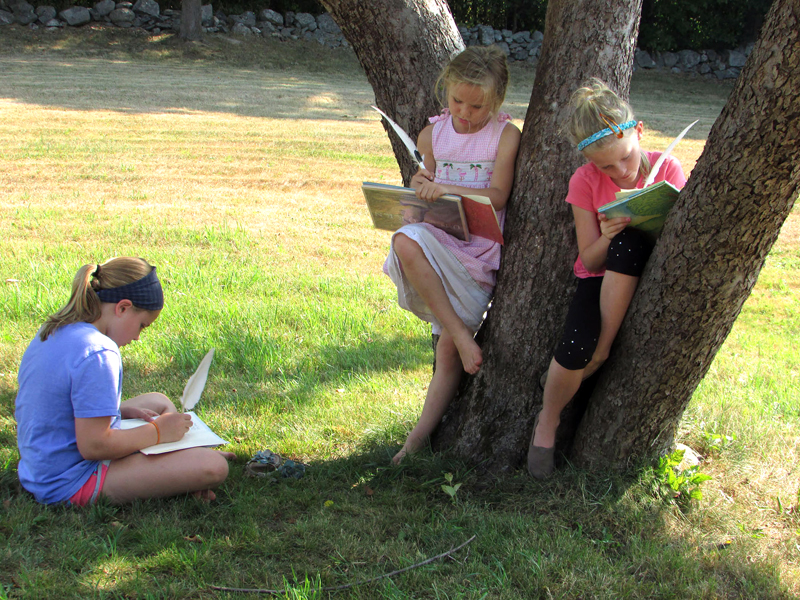 From left: Harriet McKane, Addie Miller, and Piper McKane enjoy the shade at the Old Jail in Wiscasset while writing in their journals during last yearÂ’s Summer with the Past program.