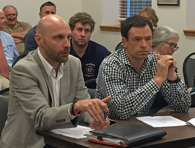 Austin Turner (left) and John Scribner, representatives of the Dollar General and Sherwin-Williams development, discuss the construction timeline during a Damariscotta Planning Board meeting at the town office Monday, July 10. (Maia Zewert photo)